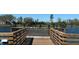 Wooden pond deck with multiple birds resting along the railing, offering a tranquil spot to observe nature at 2168 Continental St, St Cloud, FL 34769