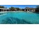 Large community pool offering clear blue water, lounge chairs, and shade cabanas at 2168 Continental St, St Cloud, FL 34769