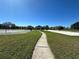 Sidewalk path leading to community sports areas featuring basketball, volleyball and picnic areas at 2168 Continental St, St Cloud, FL 34769