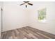 This bedroom features modern wood-look flooring, a ceiling fan, and a window with scenic outdoor views at 248 Robin Rd, Altamonte Springs, FL 32701