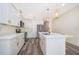 Stylish kitchen featuring white cabinets, an island, and stainless steel appliances for a modern, functional space at 248 Robin Rd, Altamonte Springs, FL 32701