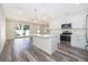 Modern kitchen with white cabinets, stainless steel appliances, an island, and contemporary pendant lighting at 248 Robin Rd, Altamonte Springs, FL 32701