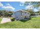 Well maintained two-story home with lush green lawn and sliding glass doors at 2581 Ponkan Summit Dr, Apopka, FL 32712