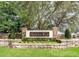 Stone entrance sign for Wekiva Run with manicured landscaping and colorful flowers at 2581 Ponkan Summit Dr, Apopka, FL 32712