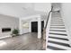 Inviting entryway with staircase and dark wood-look floors at 2581 Ponkan Summit Dr, Apopka, FL 32712