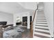 Bright and airy entryway with staircase, dark wood floors, and adjacent dining area at 2581 Ponkan Summit Dr, Apopka, FL 32712