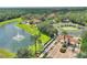 Panoramic aerial view of a community entrance, lake, and fountain, showcasing the area's landscape and amenities at 2676 Emerald Island Blvd, Kissimmee, FL 34747