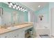 Bright bathroom featuring a large mirror, vanity area, separate shower, and soaking tub for relaxation at 2676 Emerald Island Blvd, Kissimmee, FL 34747