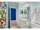 Bathroom featuring a colorful Super Mario Brothers shower curtain and blue accent wall at 2676 Emerald Island Blvd, Kissimmee, FL 34747