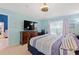 Bright bedroom with natural light, dresser with TV, and workspace at 2676 Emerald Island Blvd, Kissimmee, FL 34747