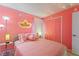 Pretty pink bedroom with princess decor, soft lighting, and cozy bedding, a dreamy escape at 2676 Emerald Island Blvd, Kissimmee, FL 34747