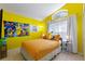 Cheerful bedroom with yellow walls, fun Pokémon decor, and a cozy orange bed, perfect for fans at 2676 Emerald Island Blvd, Kissimmee, FL 34747