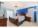 Cozy bedroom featuring a decorative ceiling fan and contrasting wall colors at 2676 Emerald Island Blvd, Kissimmee, FL 34747