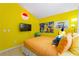 Bright bedroom with yellow walls, fun Pokémon decor, and a cozy orange bed, perfect for fans at 2676 Emerald Island Blvd, Kissimmee, FL 34747