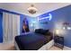 Blue bedroom with Star Wars theme, custom lights, and sleek fan creating a unique space at 2676 Emerald Island Blvd, Kissimmee, FL 34747