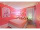 Enchanting pink bedroom with princess decor, soft lighting, and cozy bedding, a dreamy escape at 2676 Emerald Island Blvd, Kissimmee, FL 34747