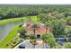 Stunning aerial view of clubhouse amenities with lush landscaping, pool and palm trees with pond views at 2676 Emerald Island Blvd, Kissimmee, FL 34747