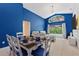 Living room featuring dining area with seating for six, a sliding glass door, and a pool view at 2676 Emerald Island Blvd, Kissimmee, FL 34747