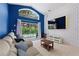 Bright living room with large sliding doors to pool area and decorative accent wall at 2676 Emerald Island Blvd, Kissimmee, FL 34747