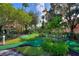 Well-maintained community mini golf course, surrounded by lush greenery and trees at 2676 Emerald Island Blvd, Kissimmee, FL 34747