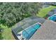 Aerial view of private screened pool with inviting blue water and ample patio space for relaxation at 2676 Emerald Island Blvd, Kissimmee, FL 34747