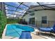 Inviting screened-in pool with clear blue water and lounge chairs for relaxation and poolside enjoyment at 2676 Emerald Island Blvd, Kissimmee, FL 34747