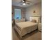 Cozy bedroom with bed, nightstand, dresser, and a ceiling fan at 272 Cedar Bark Ln, Sanford, FL 32771