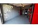 Well-organized garage with epoxy flooring, red storage cabinets, and ample workspace area at 272 Cedar Bark Ln, Sanford, FL 32771