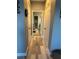 Hallway with doors on either side, leading to a bathroom with towel racks at 272 Cedar Bark Ln, Sanford, FL 32771