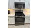 Kitchen with stainless steel gas range, microwave, and white cabinets at 272 Cedar Bark Ln, Sanford, FL 32771