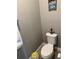 Small bathroom with a toilet, towel rack, and nautical-themed decor at 272 Cedar Bark Ln, Sanford, FL 32771