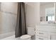 Well-lit bathroom includes a shower with gray curtain and a single sink vanity at 2729 Timbergrove St, St Cloud, FL 34771