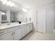 Bright bathroom showcasing double sinks with white cabinetry and ample counter space at 2729 Timbergrove St, St Cloud, FL 34771