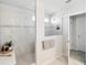 Modern bathroom featuring a glass-enclosed shower, decorative tile accent, and neutral color palette at 2729 Timbergrove St, St Cloud, FL 34771