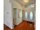 Welcoming foyer with hardwood floors and decorative shelving at 2801 Hardenbergh Ln, Eustis, FL 32726