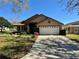 Charming home with large front yard and driveway leading to a two car garage at 2801 Hardenbergh Ln, Eustis, FL 32726