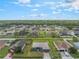 An aerial perspective of the home highlighting the front yard, showcasing the property's curb appeal and surrounding landscaping at 2851 Stonewood Cir, Lakeland, FL 33810