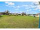 Expansive green backyard with blue skies, fluffy clouds, and plenty of space for activities at 2851 Stonewood Cir, Lakeland, FL 33810