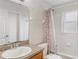 Bathroom features a single sink with a patterned shower curtain covering the bathtub at 2851 Stonewood Cir, Lakeland, FL 33810