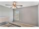 Neutral bedroom features a ceiling fan and natural light from the window with blinds at 2851 Stonewood Cir, Lakeland, FL 33810