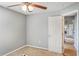 This is a light gray bedroom with a doorway, white door, ceiling fan, and carpet at 2851 Stonewood Cir, Lakeland, FL 33810