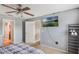 This bedroom features a ceiling fan, and wall-mounted TV for ultimate comfort and entertainment at 2851 Stonewood Cir, Lakeland, FL 33810