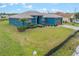 Charming blue single Gathering home with lush green lawn, mature landscaping, and inviting curb appeal at 2851 Stonewood Cir, Lakeland, FL 33810