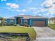 Attractive single Gathering home with blue exterior, a manicured lawn, and a two car garage at 2851 Stonewood Cir, Lakeland, FL 33810