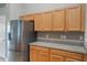 A kitchen with stainless steel refrigerator and wooden cabinets at 2851 Stonewood Cir, Lakeland, FL 33810