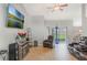 Comfortable living room featuring tile floors, vaulted ceilings, and sliding glass door to backyard at 2851 Stonewood Cir, Lakeland, FL 33810