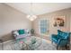 Cozy living room featuring settee, plush rug, decorative chandelier and colorful decor at 2851 Stonewood Cir, Lakeland, FL 33810