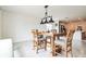 Bright dining area featuring a wooden table with cushioned chairs and a modern light fixture at 2925 Sw 172Nd Lane Rd, Ocala, FL 34473