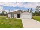 Charming single-story home featuring a well-manicured lawn and a two-car garage, perfect for a Gathering at 2925 Sw 172Nd Lane Rd, Ocala, FL 34473