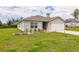 Charming single-story home with a well-manicured lawn and a freshly painted white garage door at 2925 Sw 172Nd Lane Rd, Ocala, FL 34473